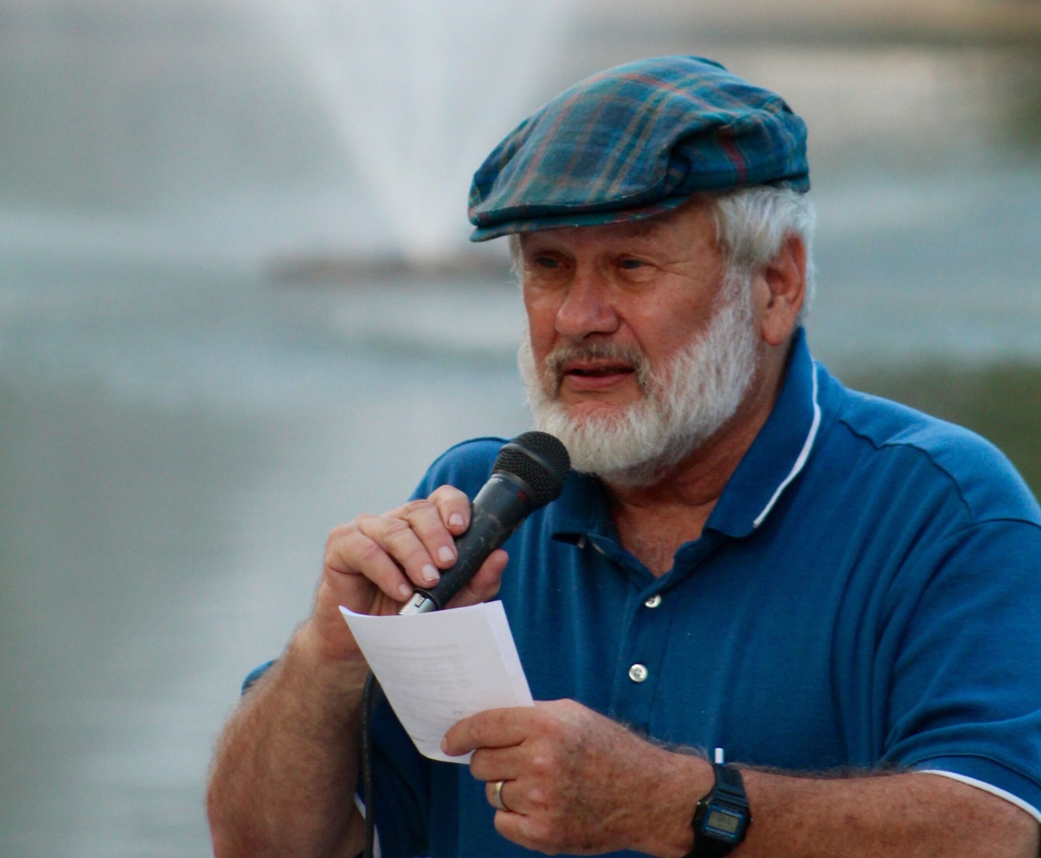 Ron Faust shares a poem at Loose Park at a PeaceWorks Hiroshima/Nagasaki Remembrance.